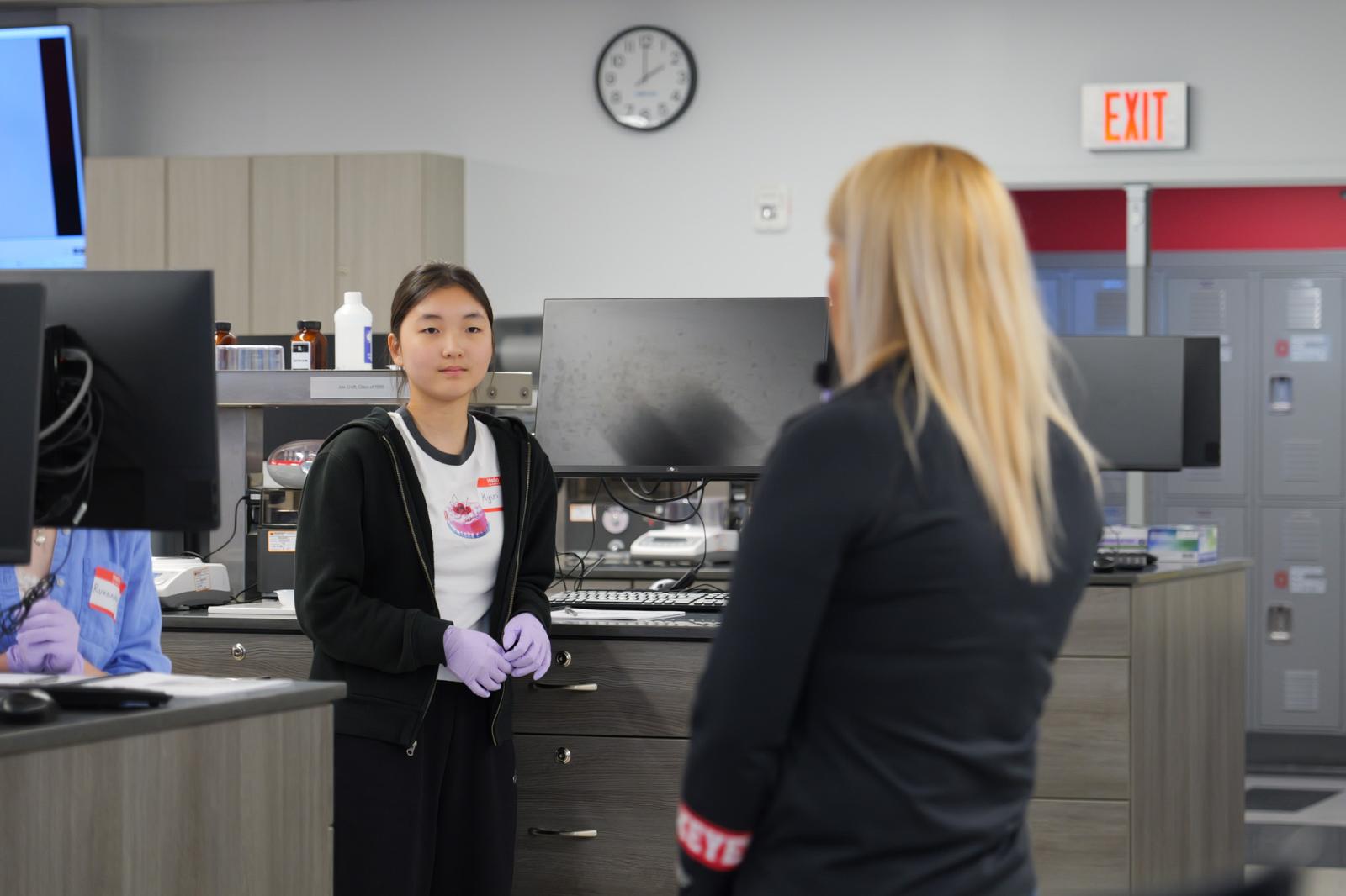 Student at a lab bench listening to instructor
