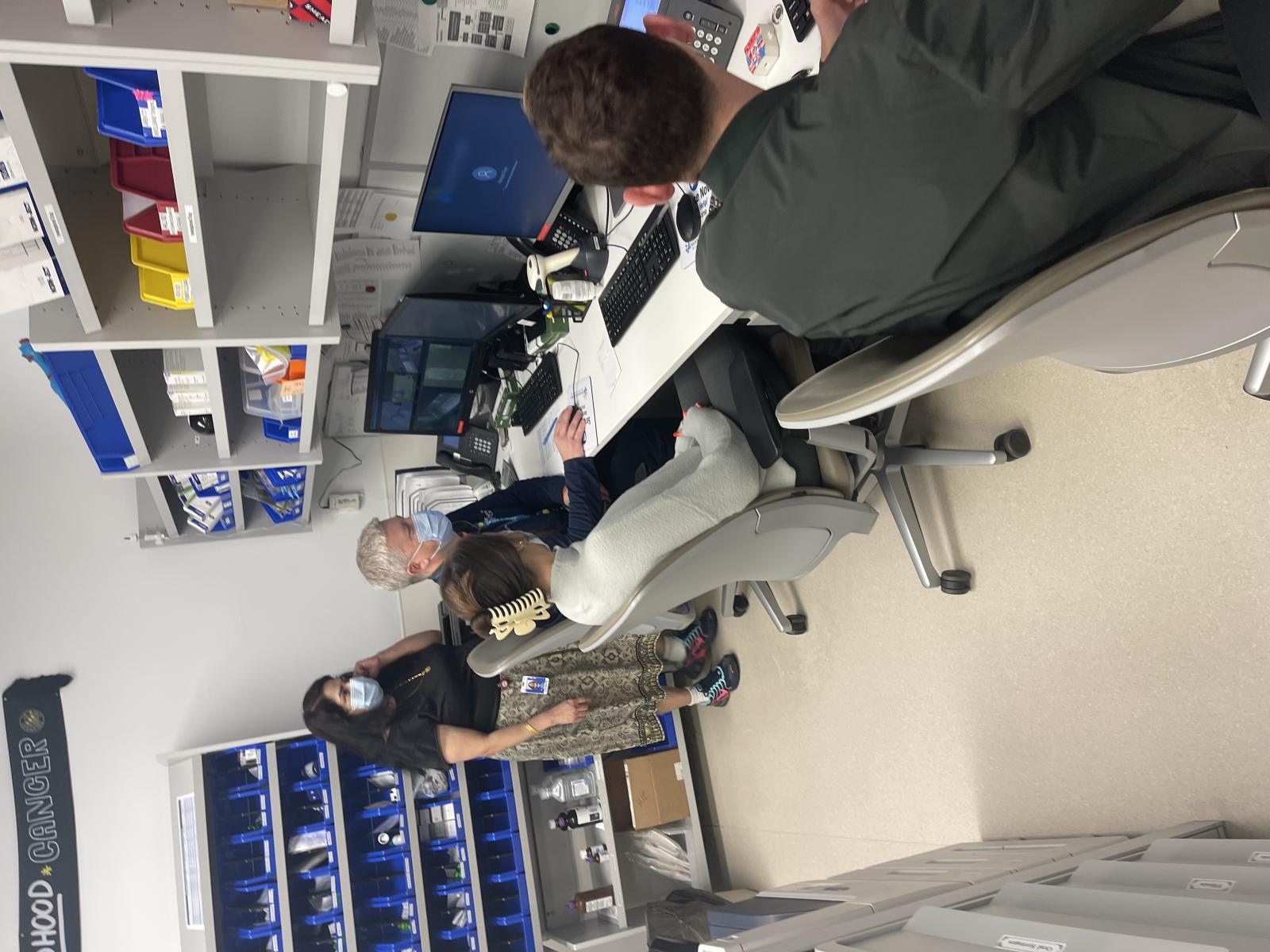 Dr. Pai reviewing patient records with other fellow pharmacists