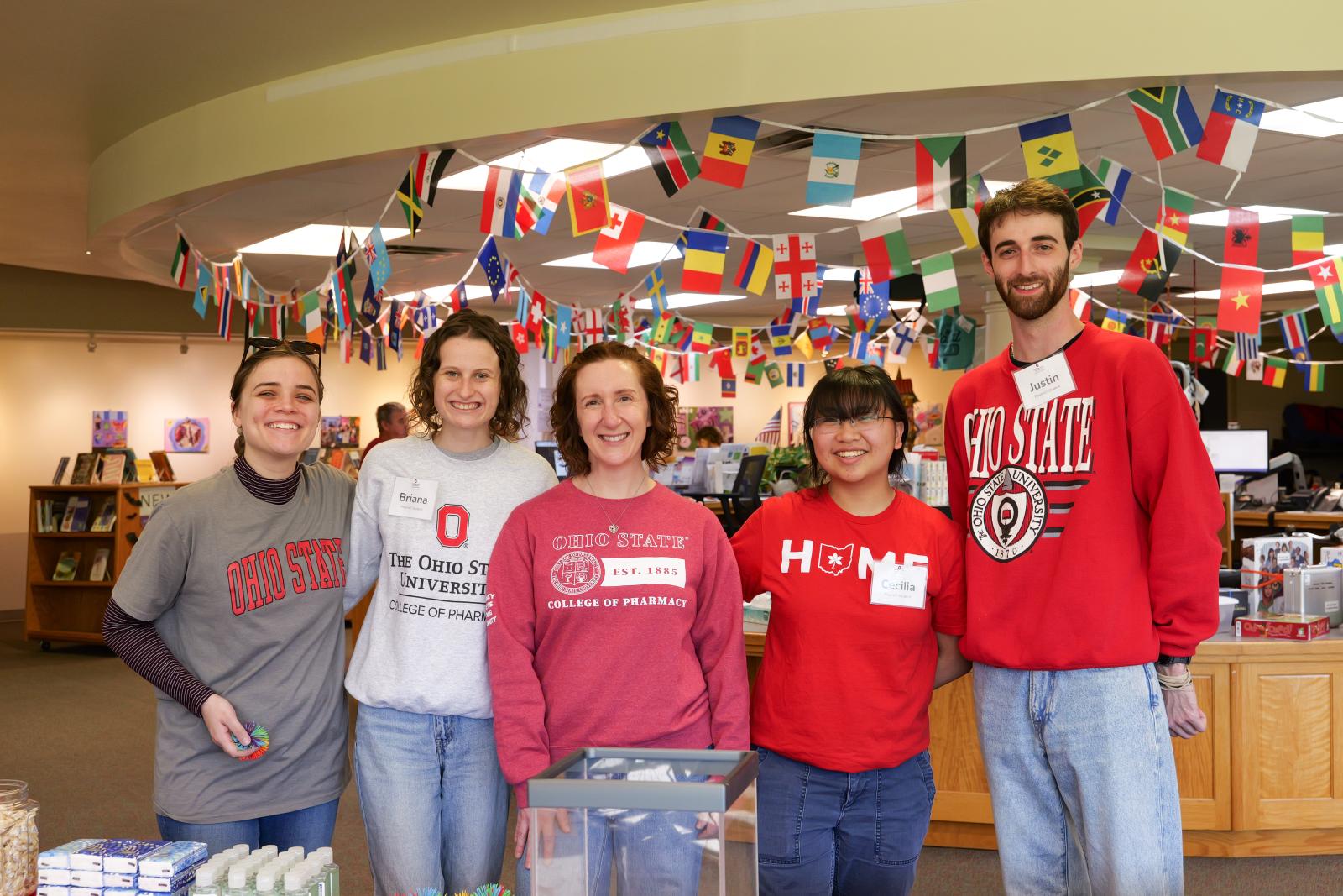 A group of students and staff at a vaccine outreach table at Athens Public Library