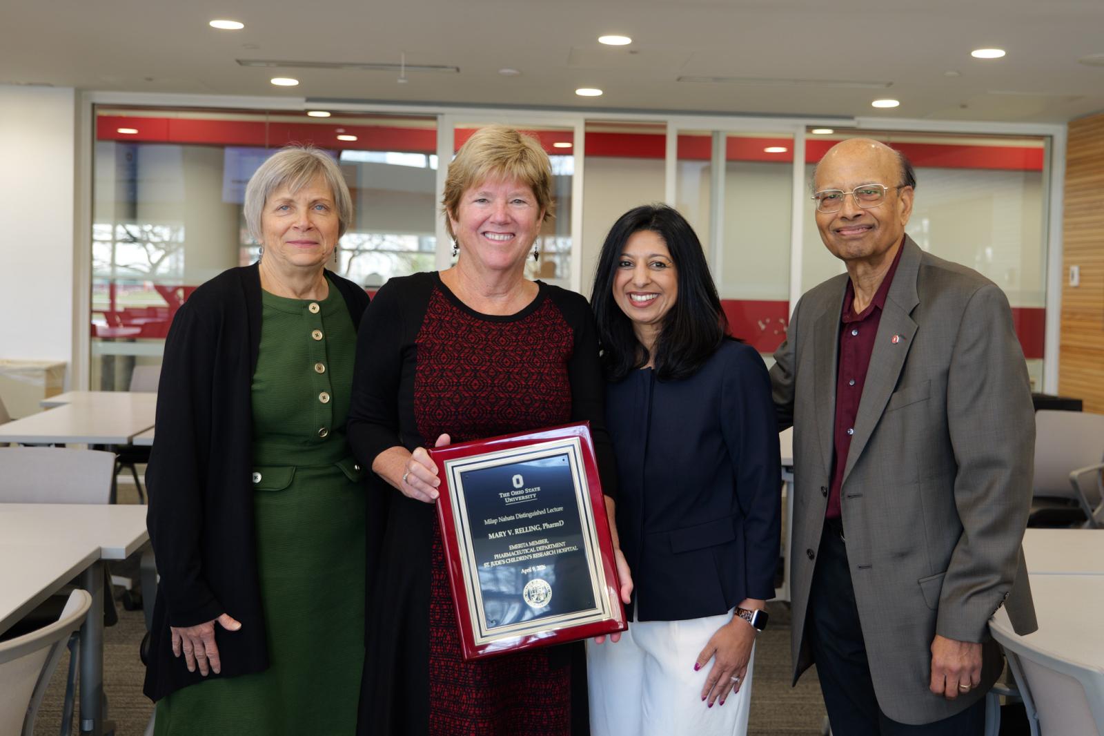 Dr. Relling with an award