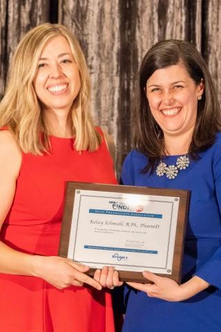Dr. Kelsey Schmuhl receiving her award