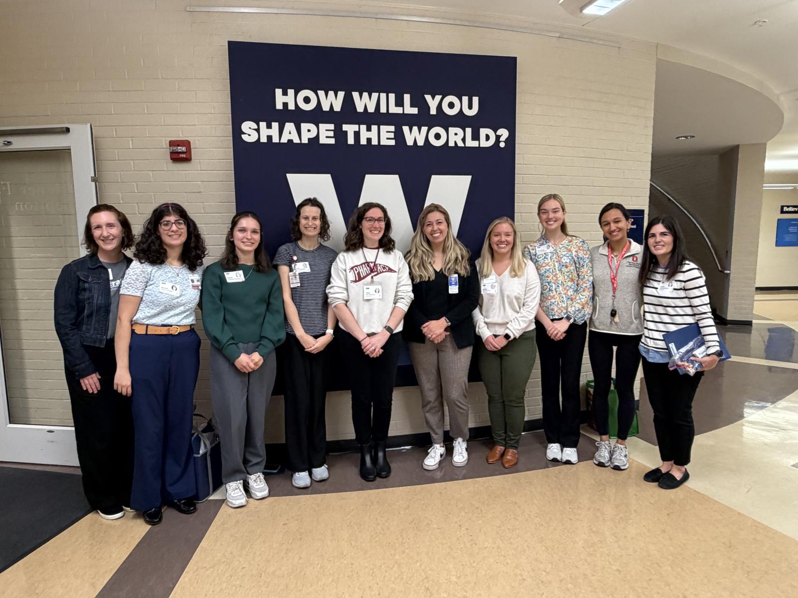 Faculty and staff smiling for a group photo in the Wellington Lower School.