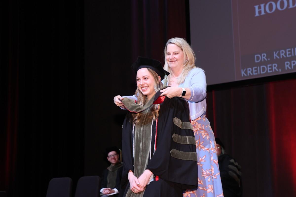 Tammy Kreider hoods her daughter, Dr. Alyssa Kreider