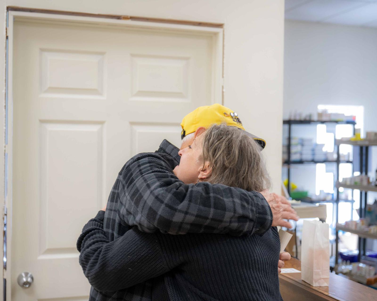 Dr. Adkins hugging a patient at Rising Suns