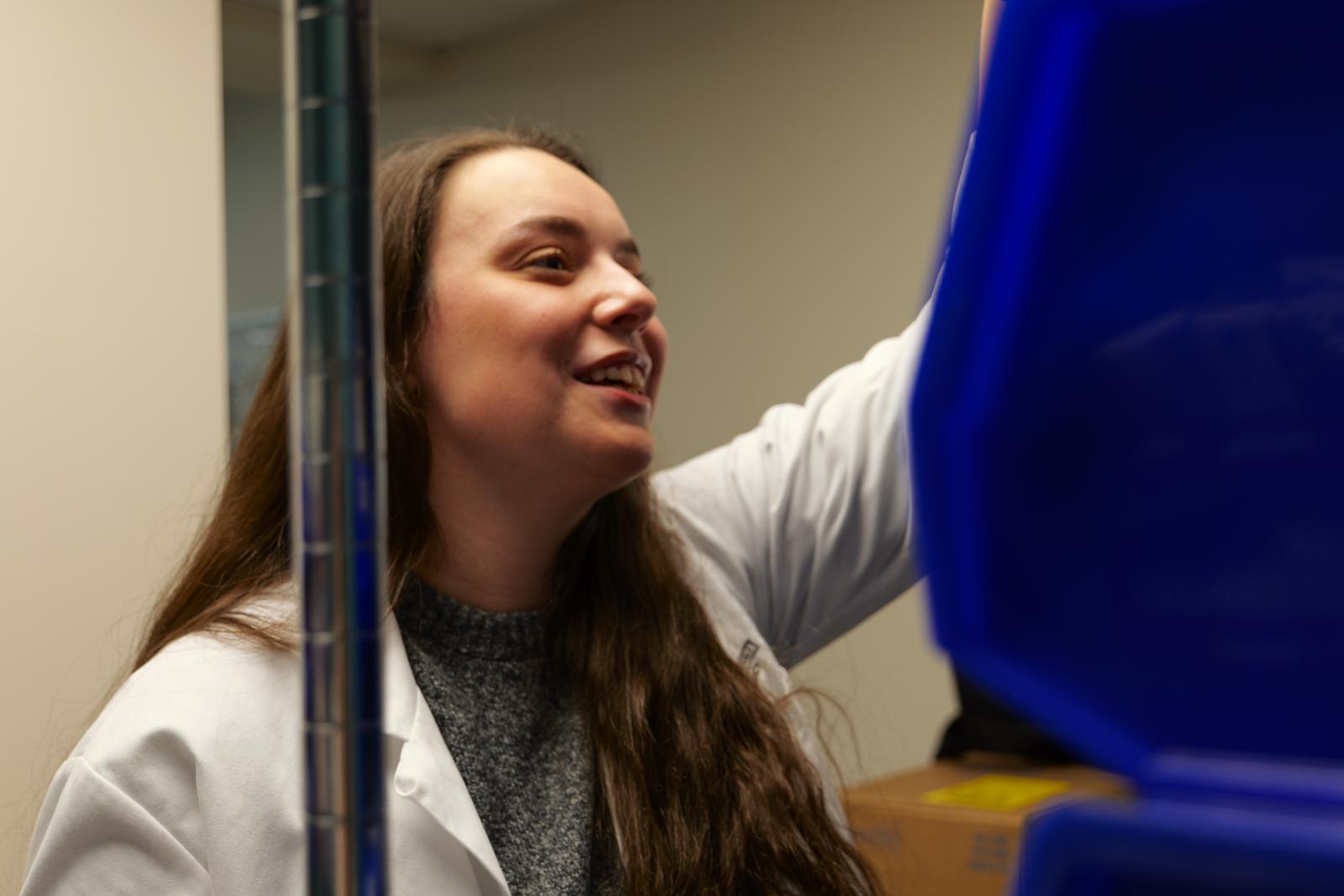 Rachel Hopper grabbing items off of the pharmacy shelf at OhioHealth
