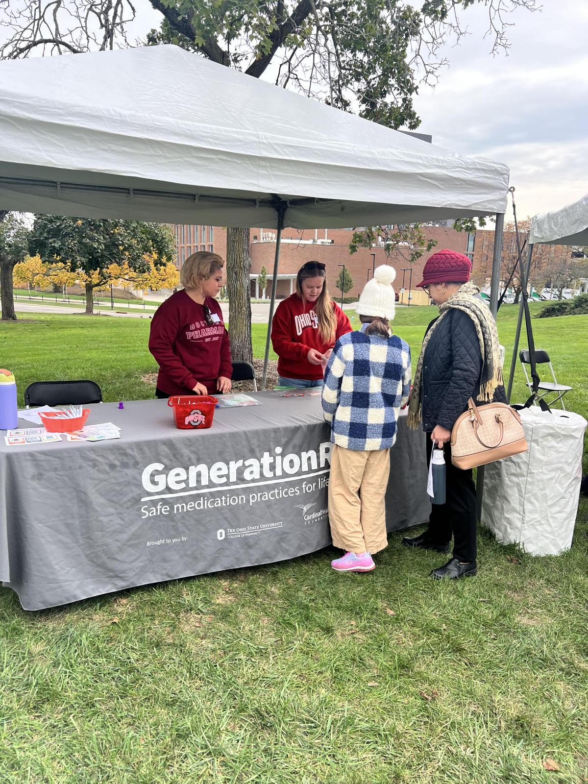 Two individuals talking at on of the tables. 