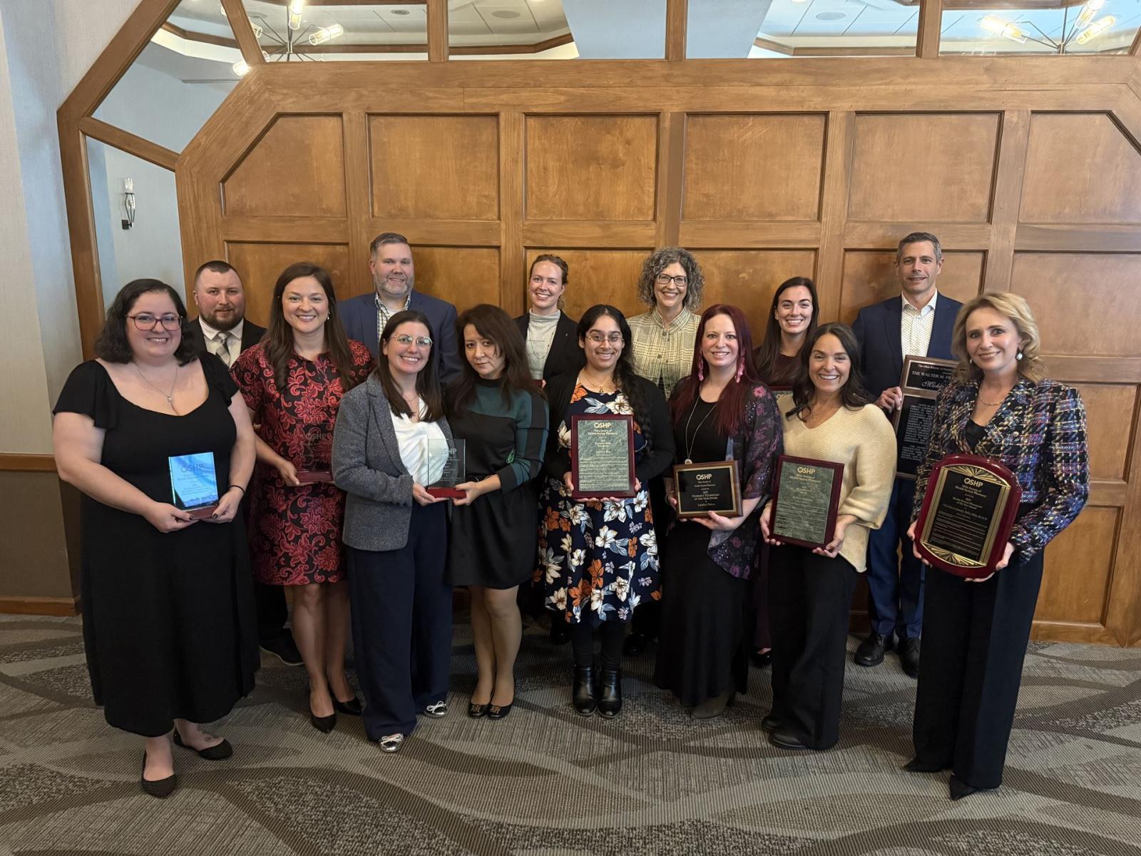 Awardees smiling in a group photo from the annual meeting. 