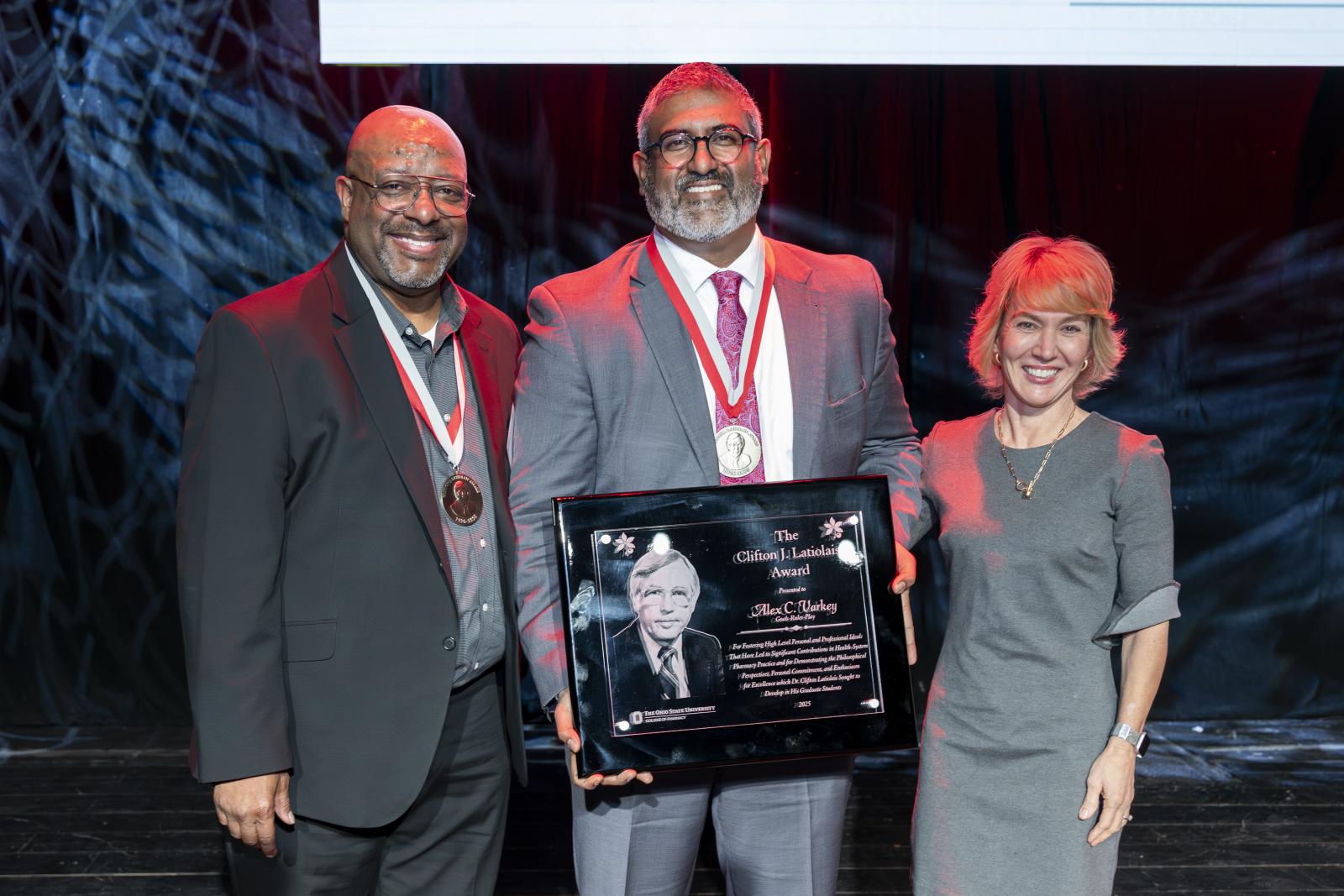 Alex Varkey holding his award