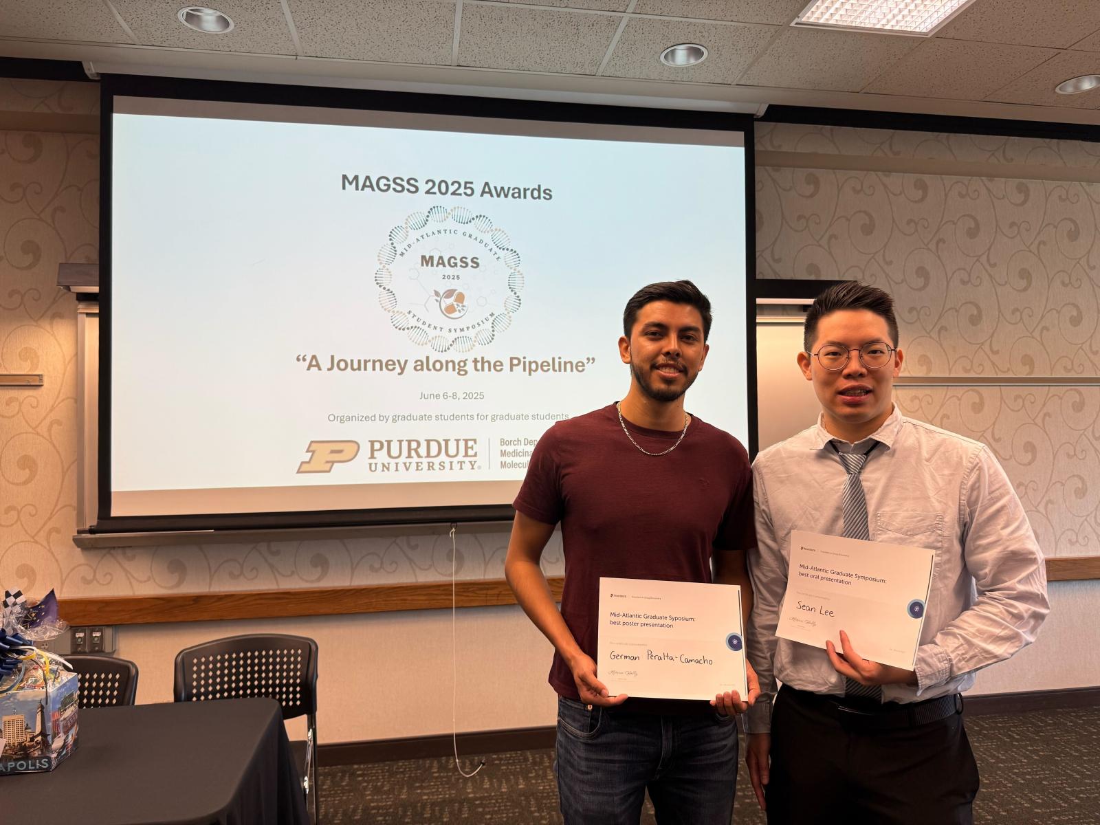 Peralta-Camacho and Lee posing with their award certificates at MAGSS 2025