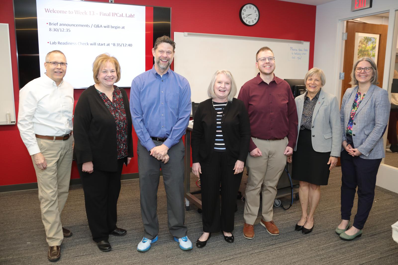 Members of the college celebrating with Dr. Matthews