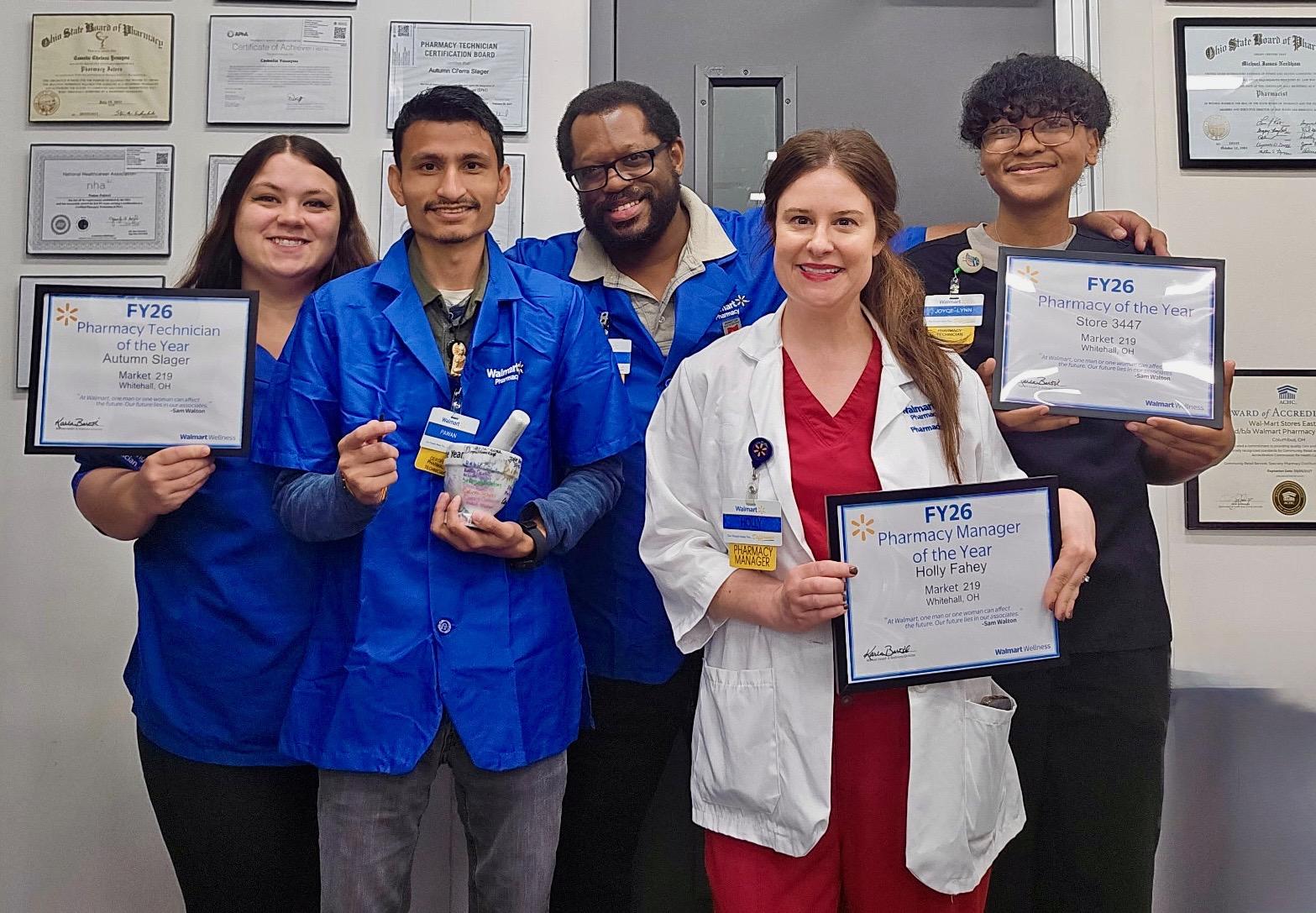 Dr. Fahey in a group holding awards
