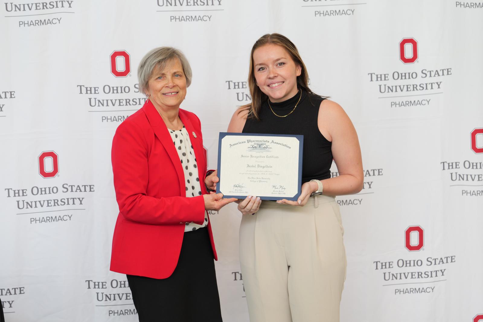 student and dean pose with certificate