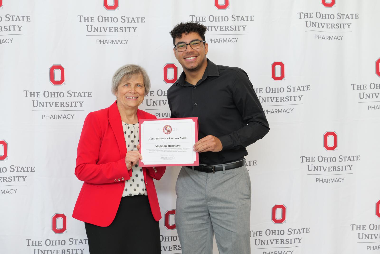 dean and student hold a certificate