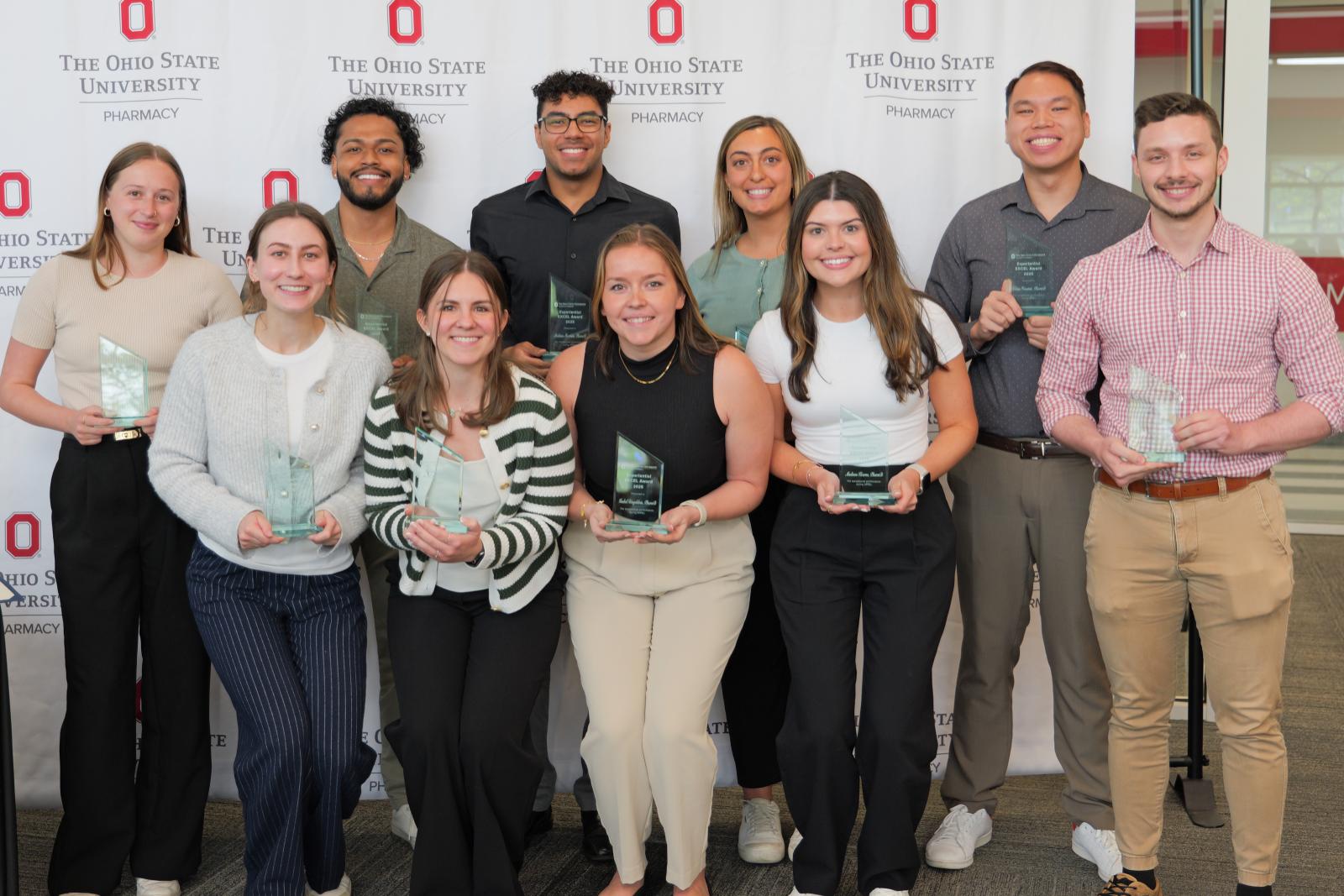 a group of students holding trophies
