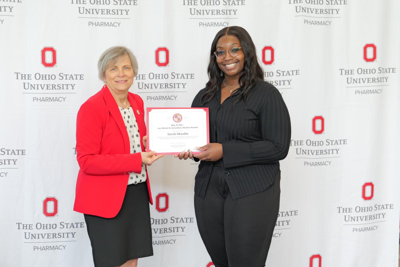 dean and a student hold a certificate