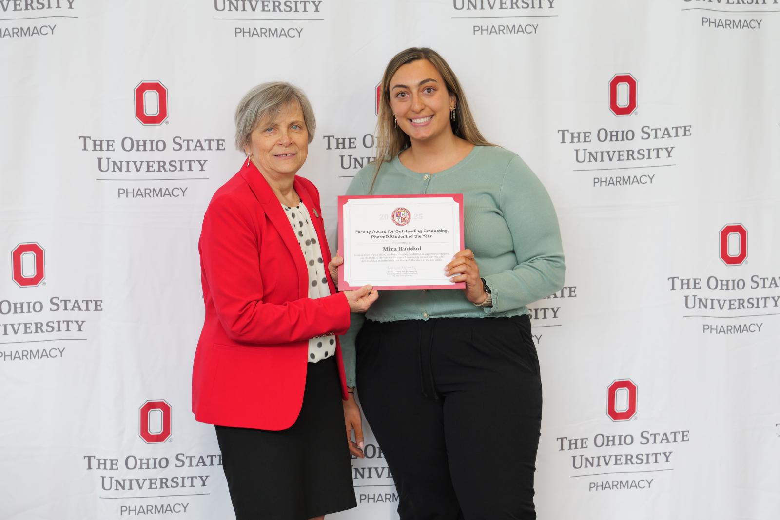 dean and student pose with certificate