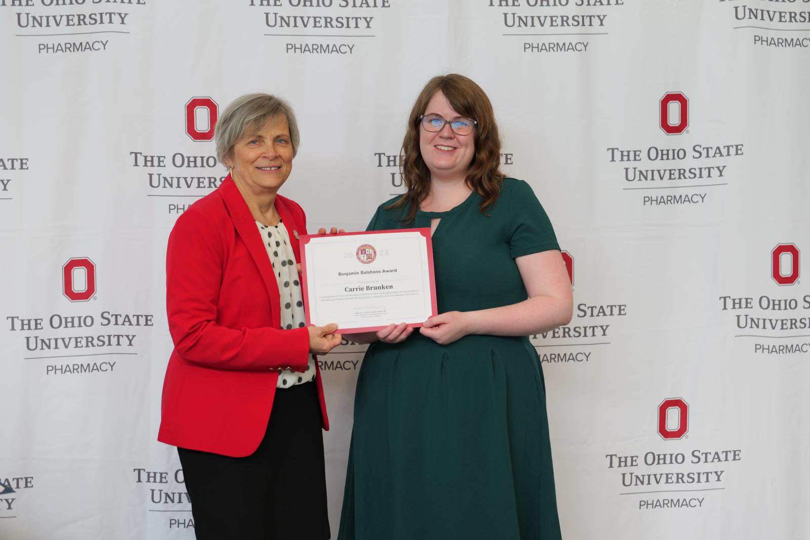 dean and student hold a certificate