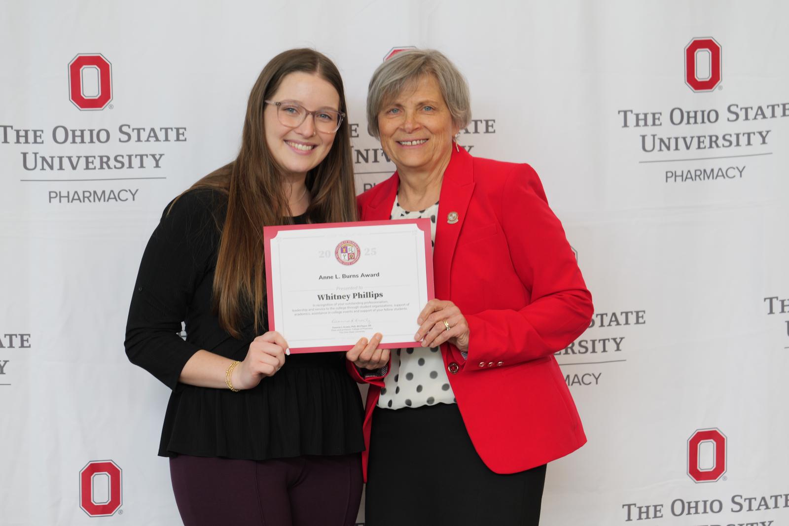 dean and student hold a certificate