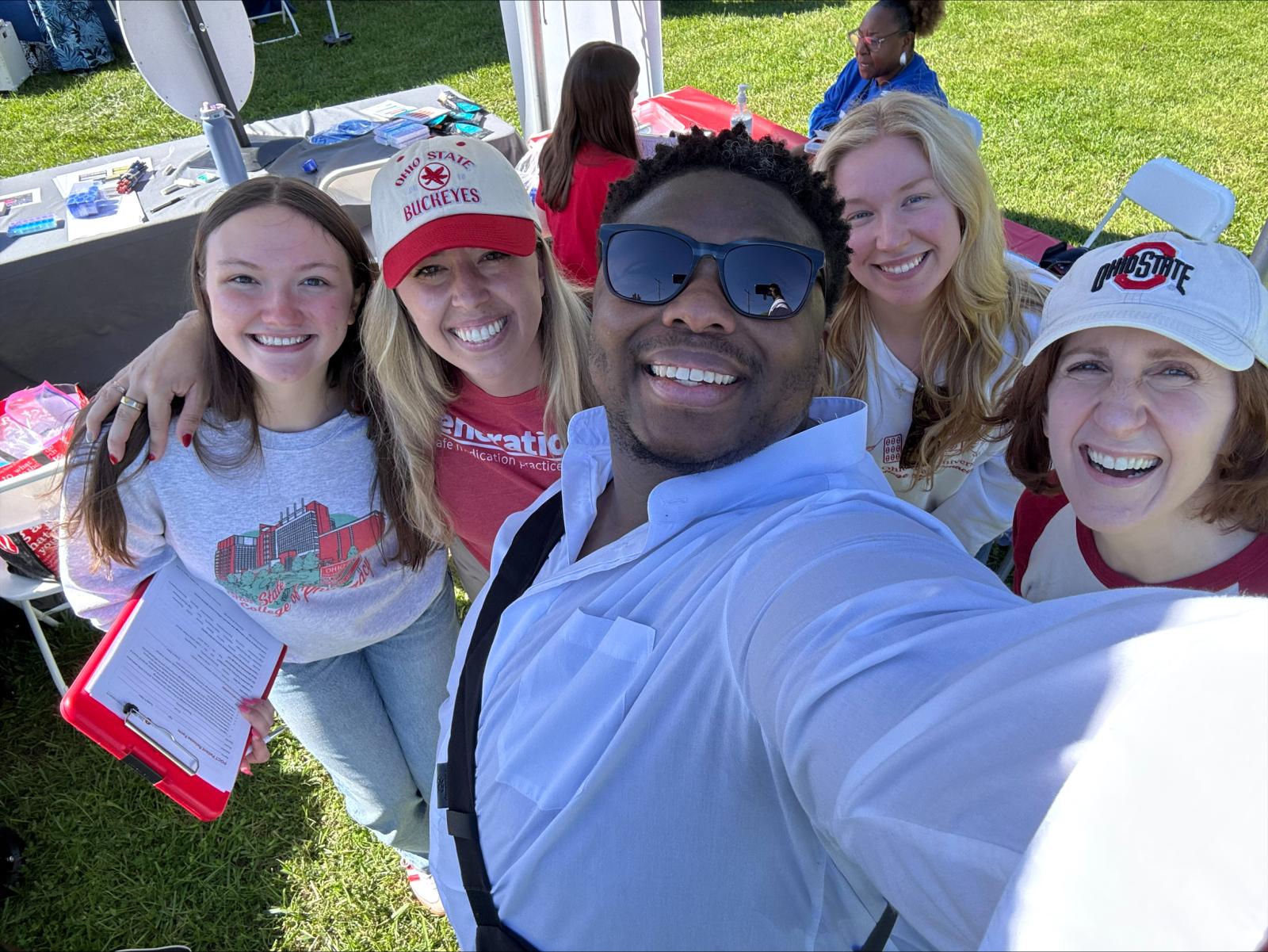 Five people smiling in OSU gear