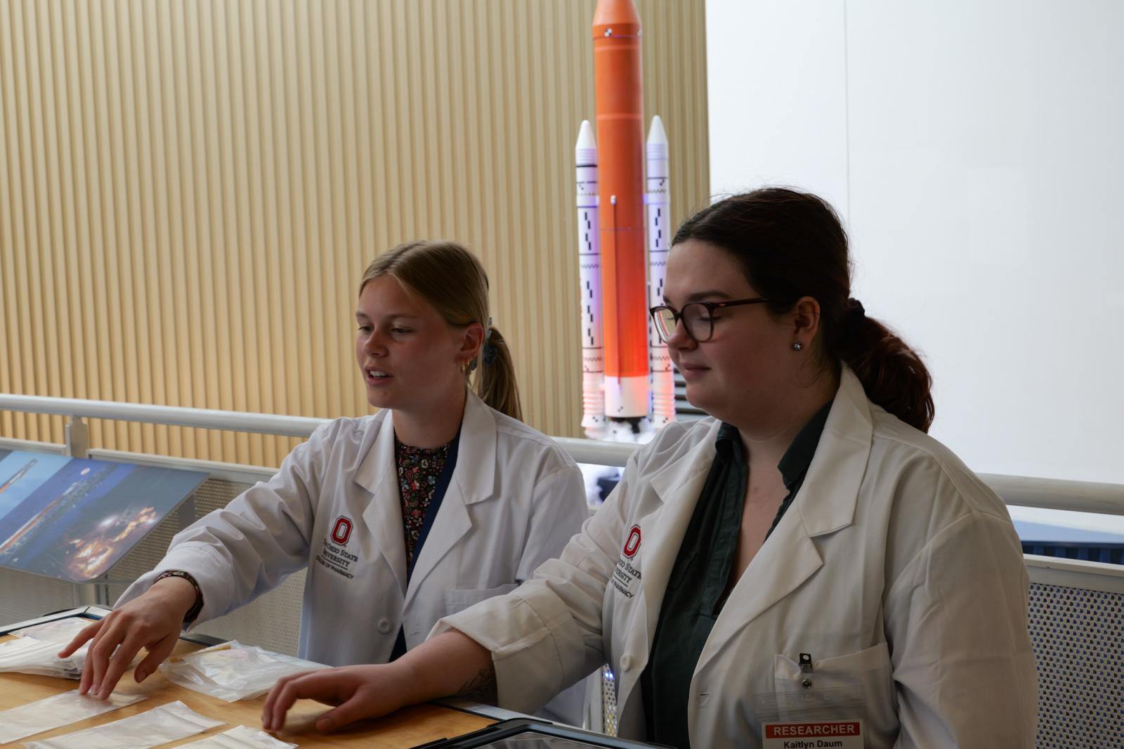 Two college of students leading outreach at COSI