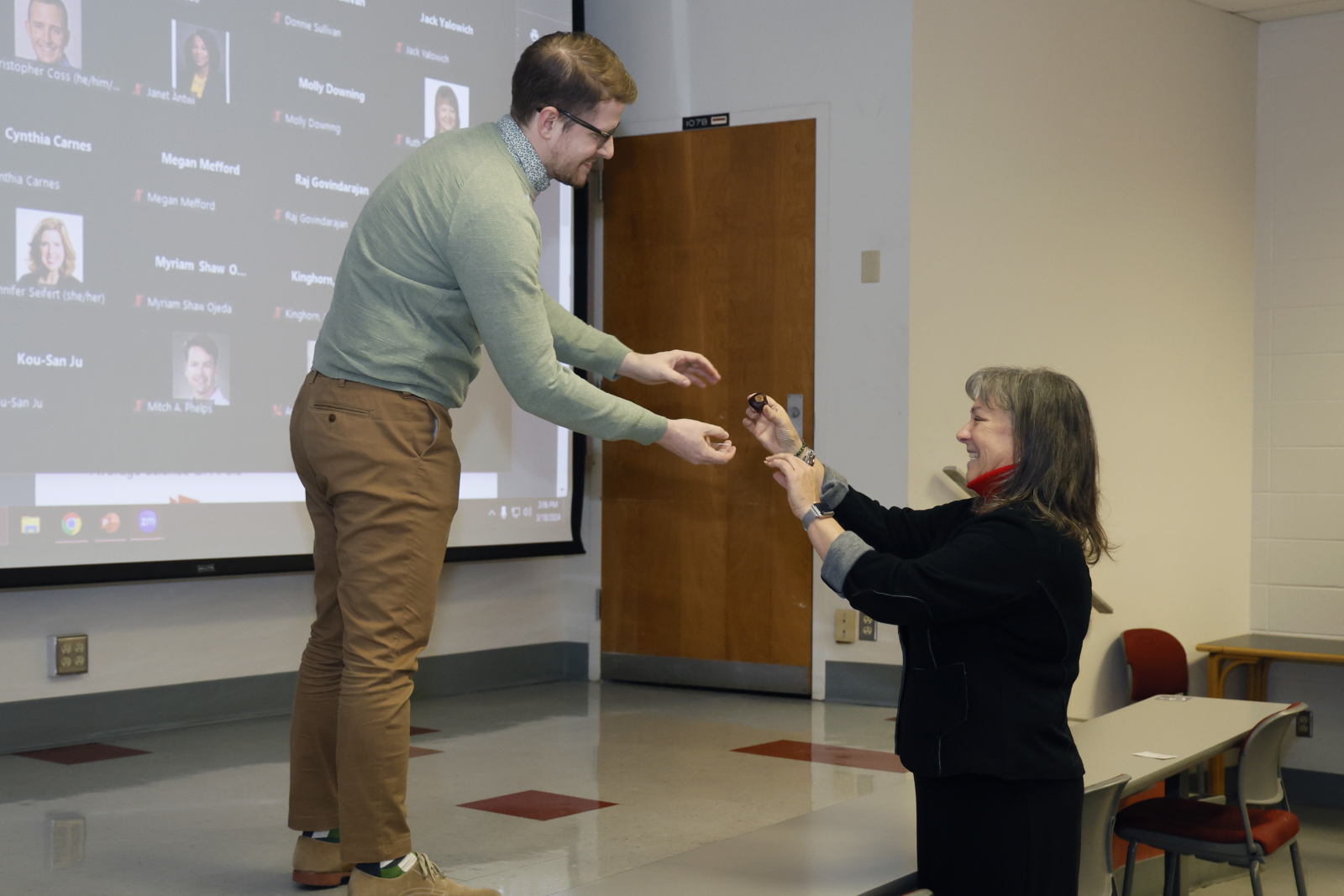 zach woods on stage receiving a celebratory buckeye from molly ranz calhoun