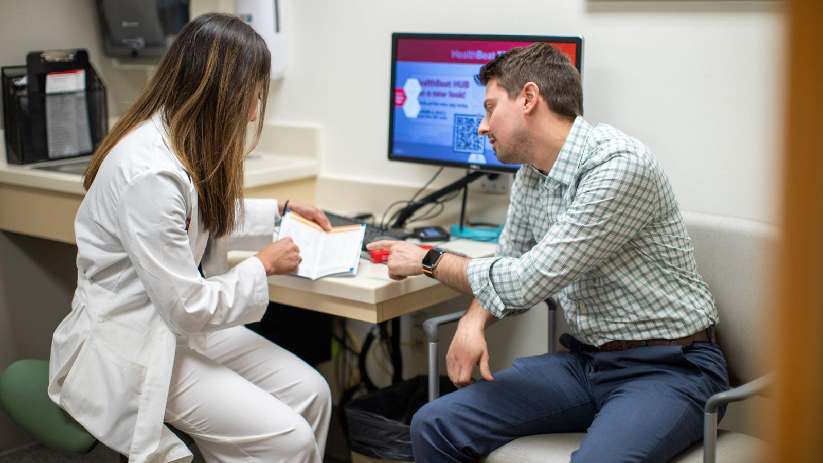 Pharmacist talking with patient about their care