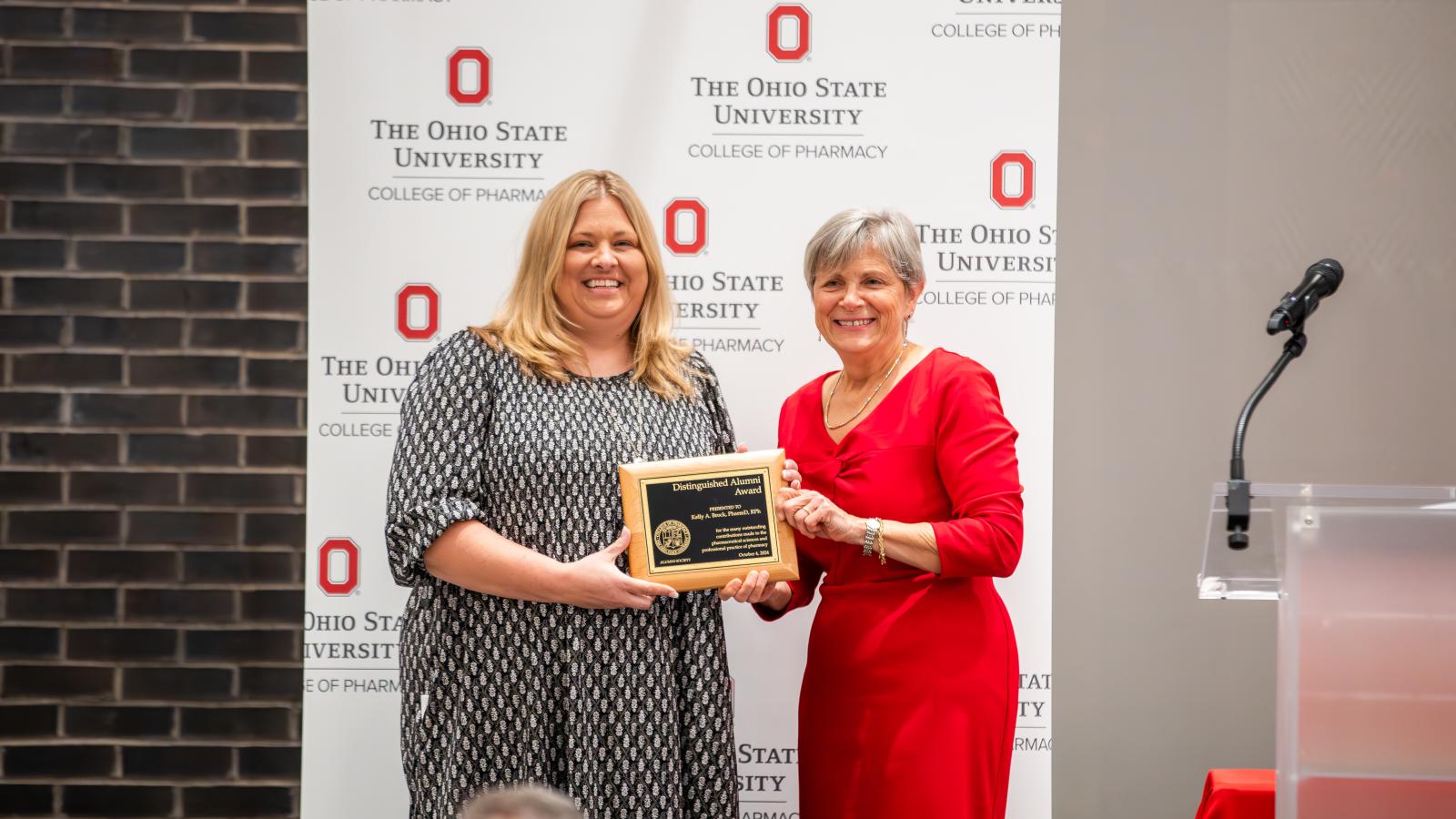 Kelly accepting award from Dean Kroetz