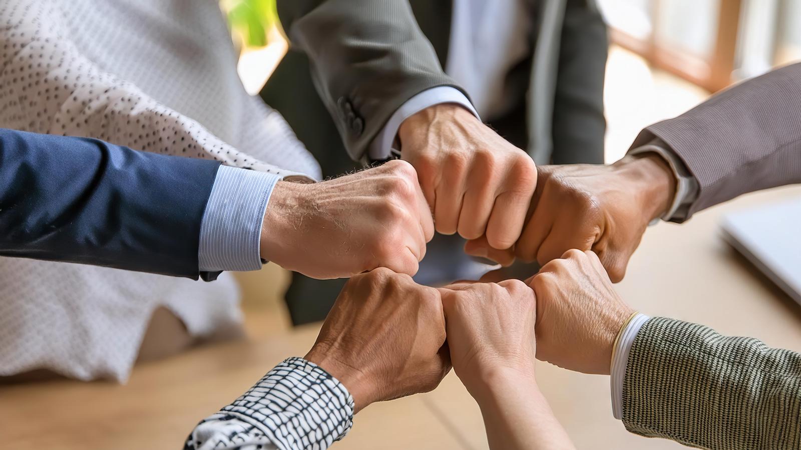 hands coming together demonstrating teamwork