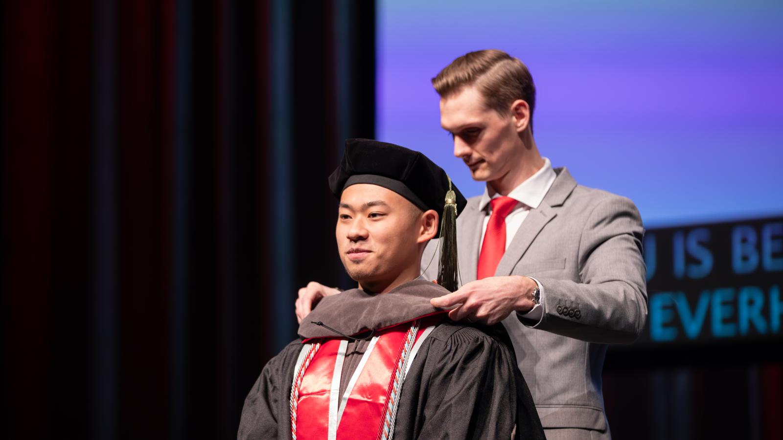 Christian Hu being hooded