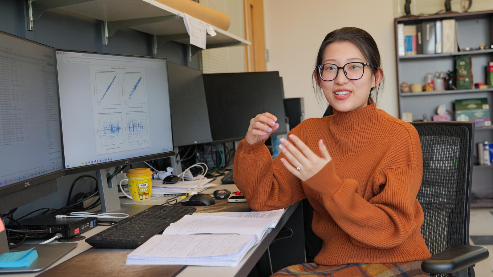 Min Hai in the Phelps graduate students' office