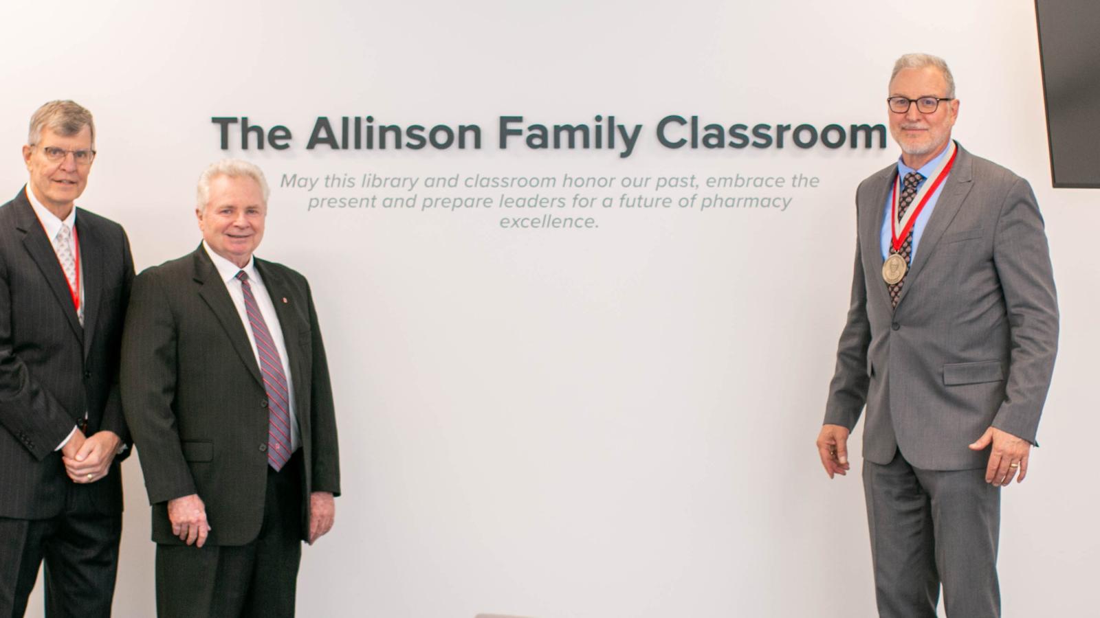 Allinson, Mann and Weber standing in front of the new "Allinson Suite" sign