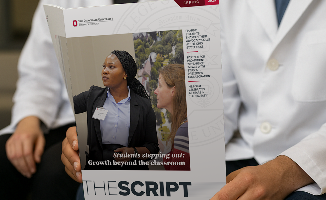 Image of white coat students reading the most-recent The Script