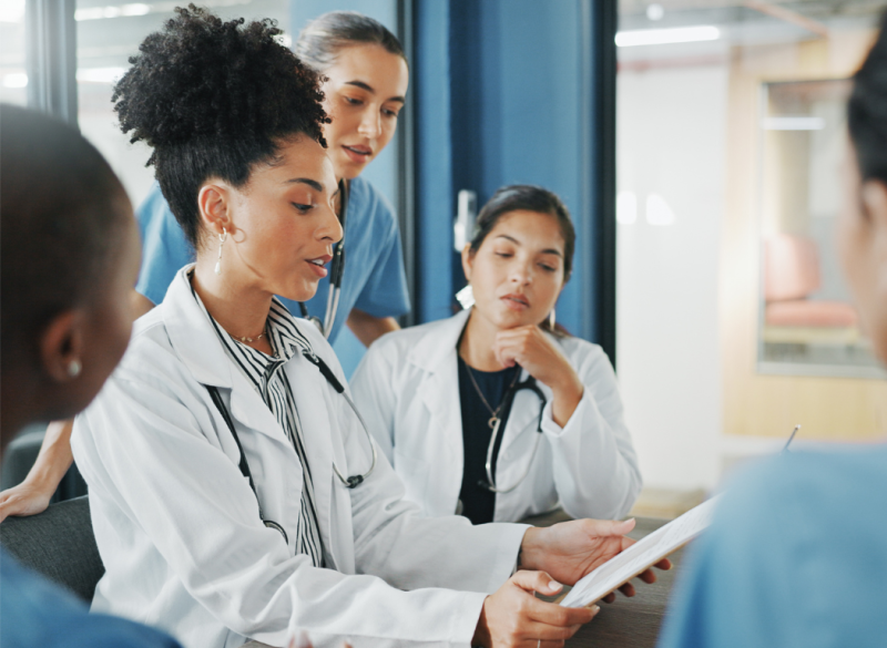 Photo of multiple students in white coats working together