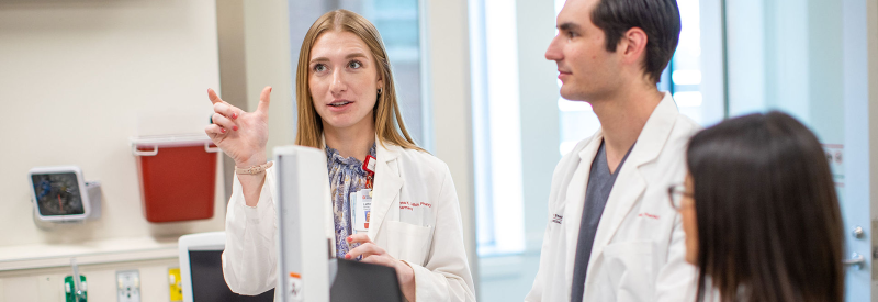 two pharmacists in white coats talking