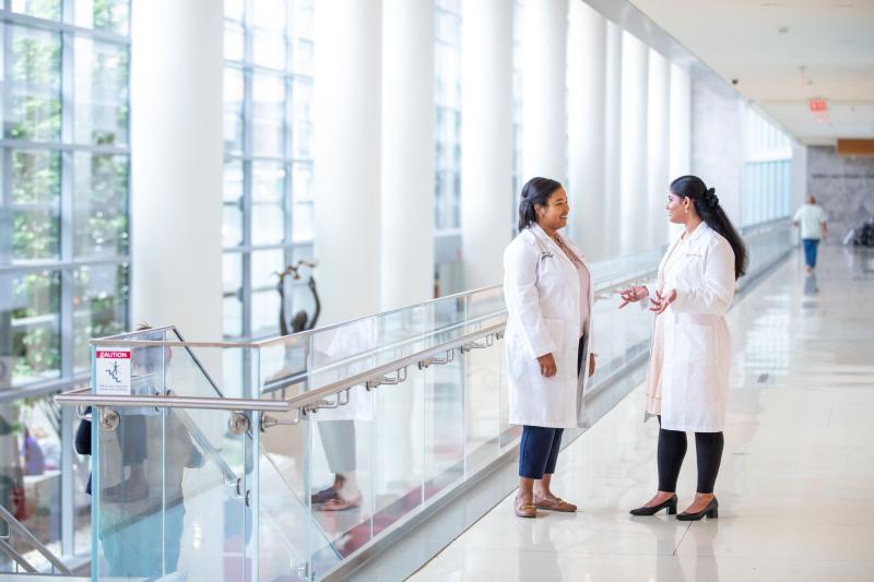 two people talking in hospital lobby