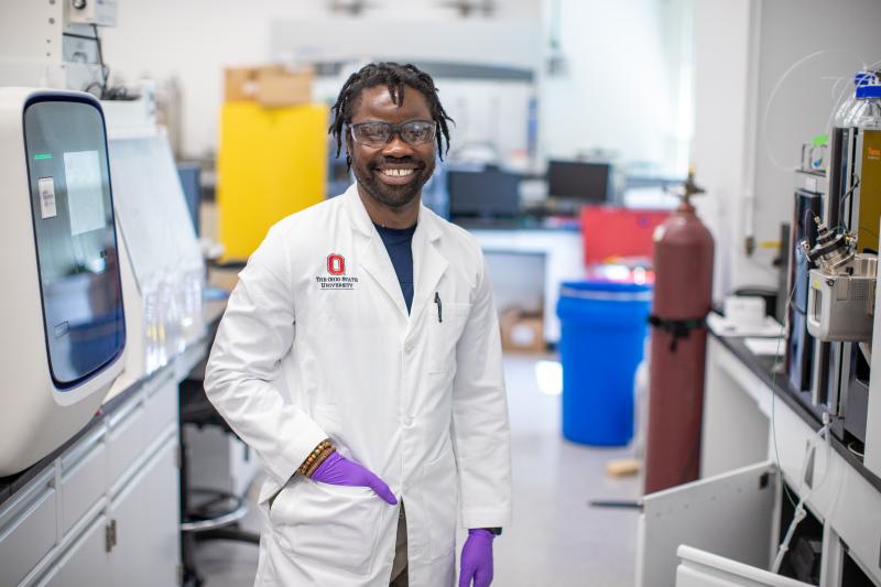 a researcher wearing a white coat in a lab