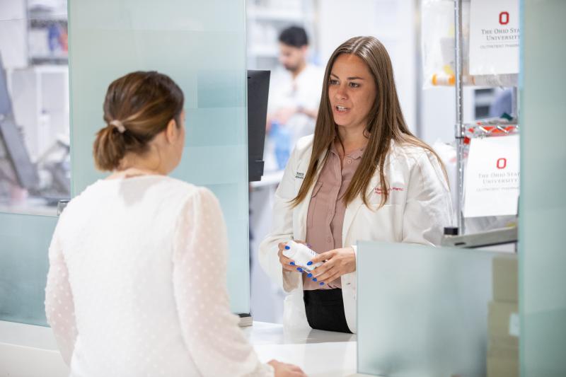 pharmacist working with a patient