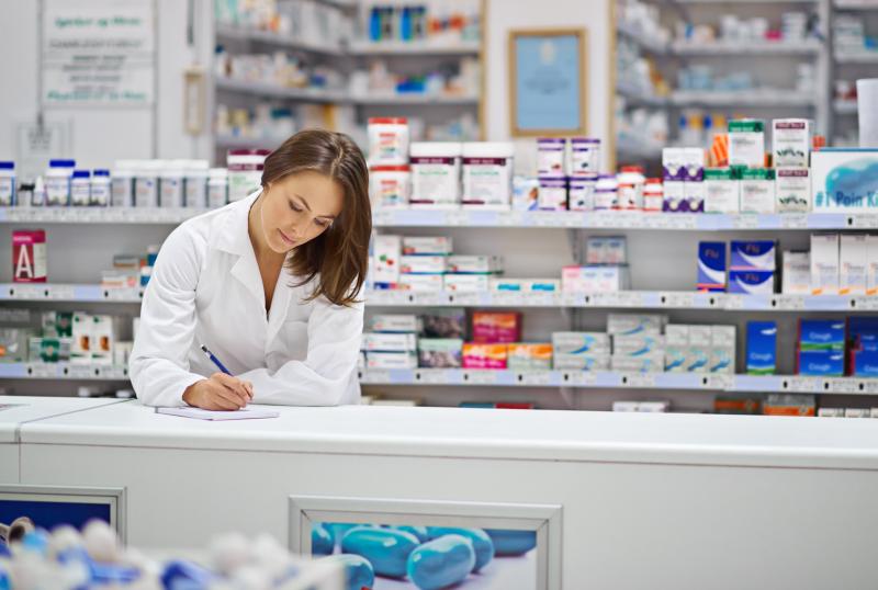a pharmacist working at a counter