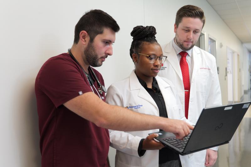 three pharmacists in a hallway