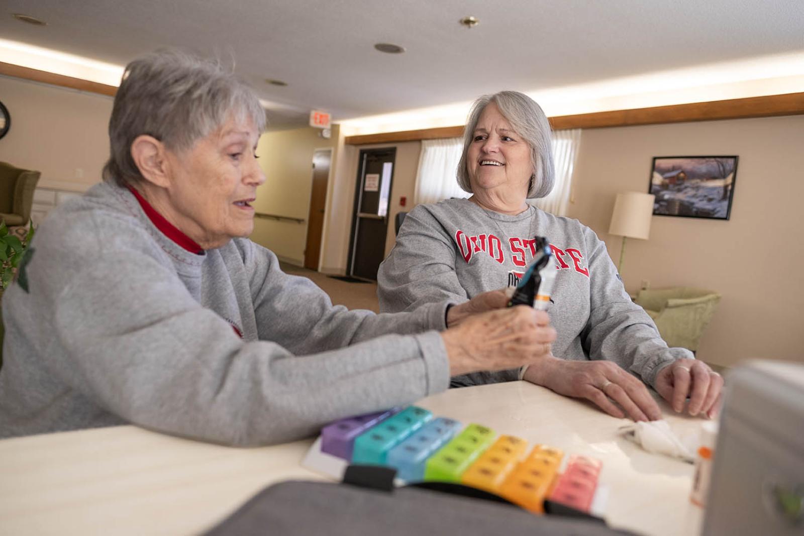Coble (right) interacts with her neighbor, Connie Stallter. As part of her role with Generation Rx, Coble works closely with her neighbors to keep them informed about proper prescription medicine use. (Corey Wilson)