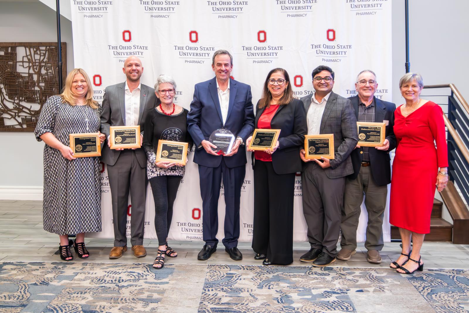 All Alumni Award Recipients standing in front of a backdrop