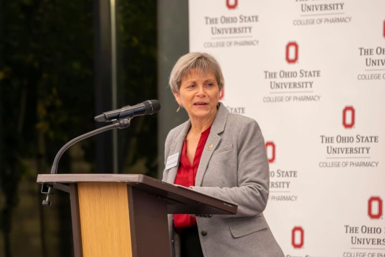 dean deanna kroetz speaking at podium