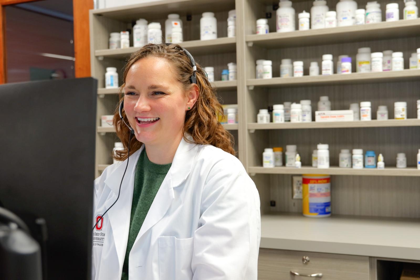 Dr. Lahrman at a computer in a community pharmacy
