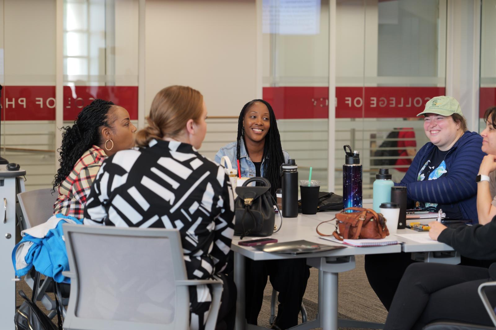 Columbus City School teachers sitting at a table in the Riffe Classroom