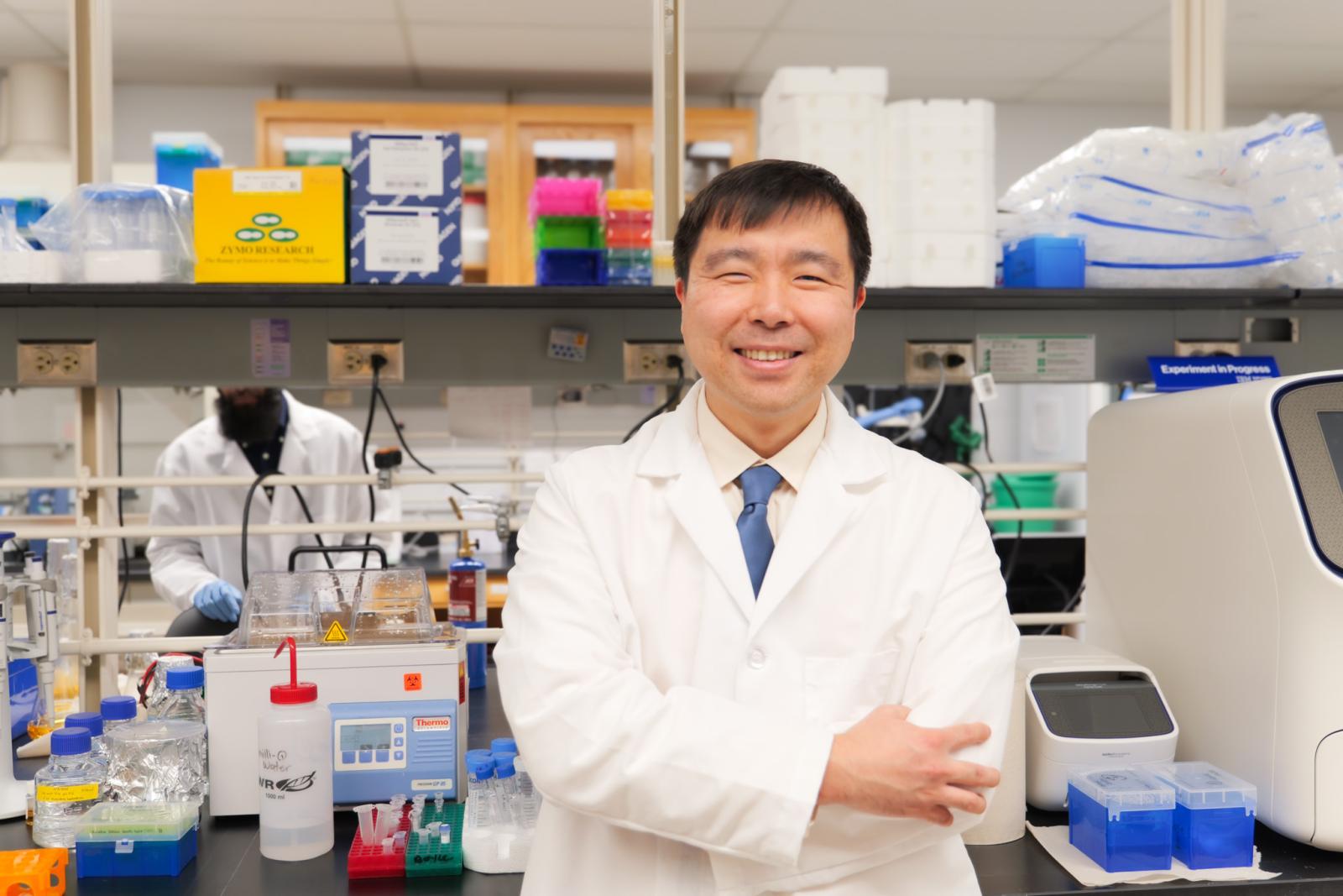 Jon Lee standing at the lab bench