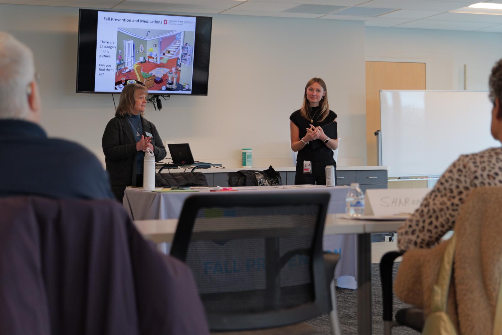 Ruth Emptage and student presenting to group of older adults