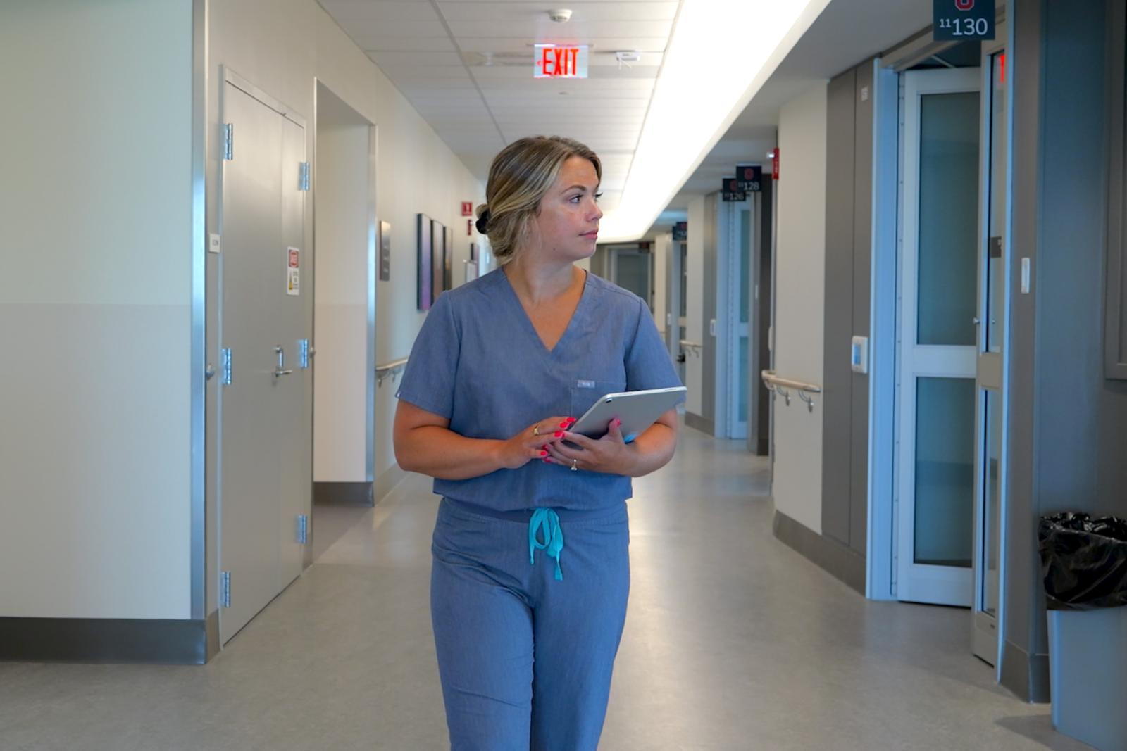Victoria Williams walking through University Hospital halls