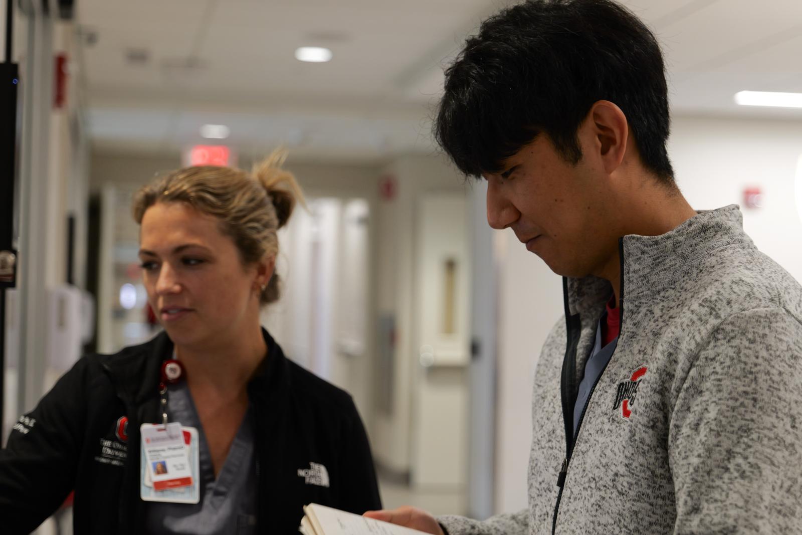 PhD Candidate Jin Gyu Kim taking notes at a computer in the ICU