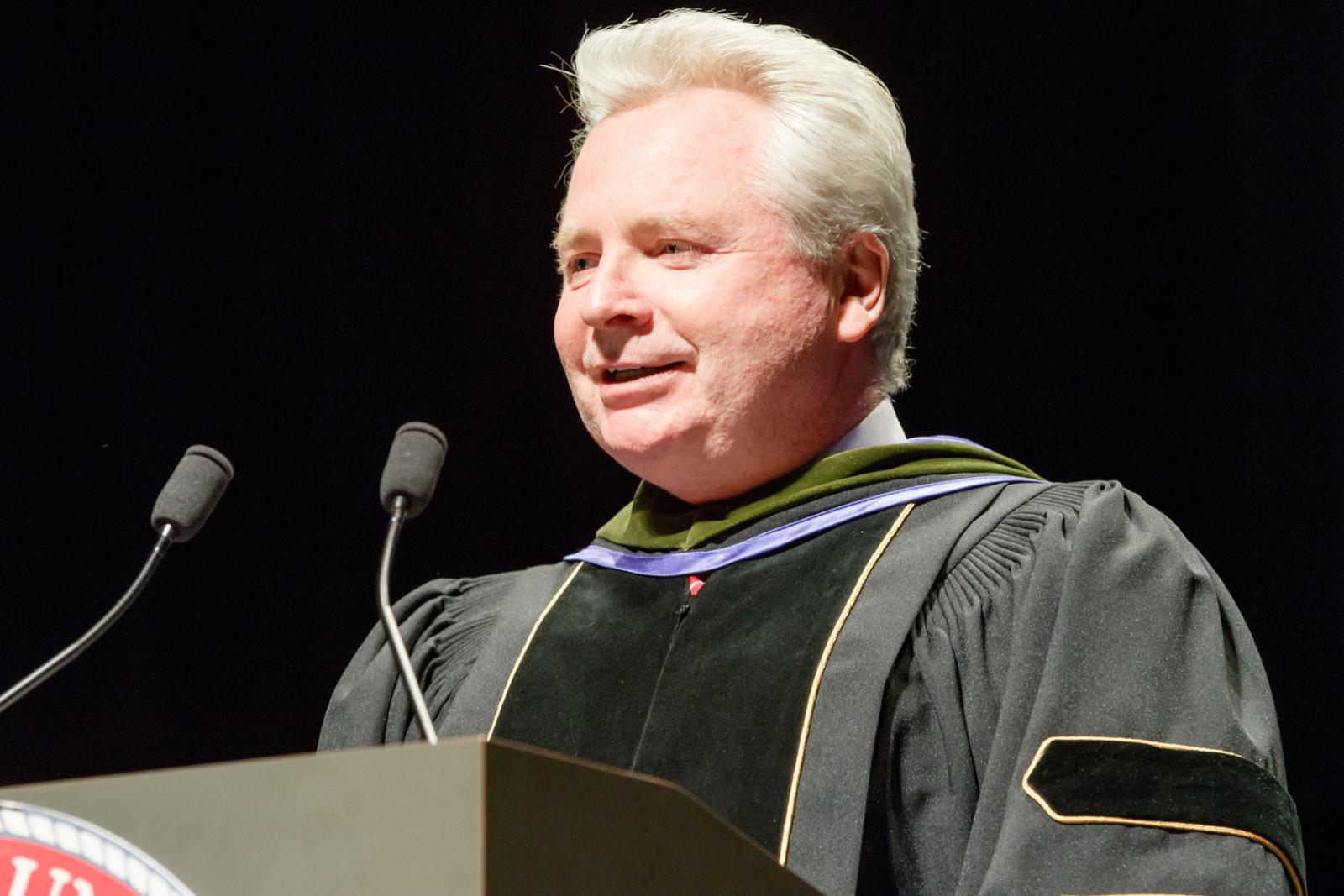 Dean Mann speaking at hooding ceremony